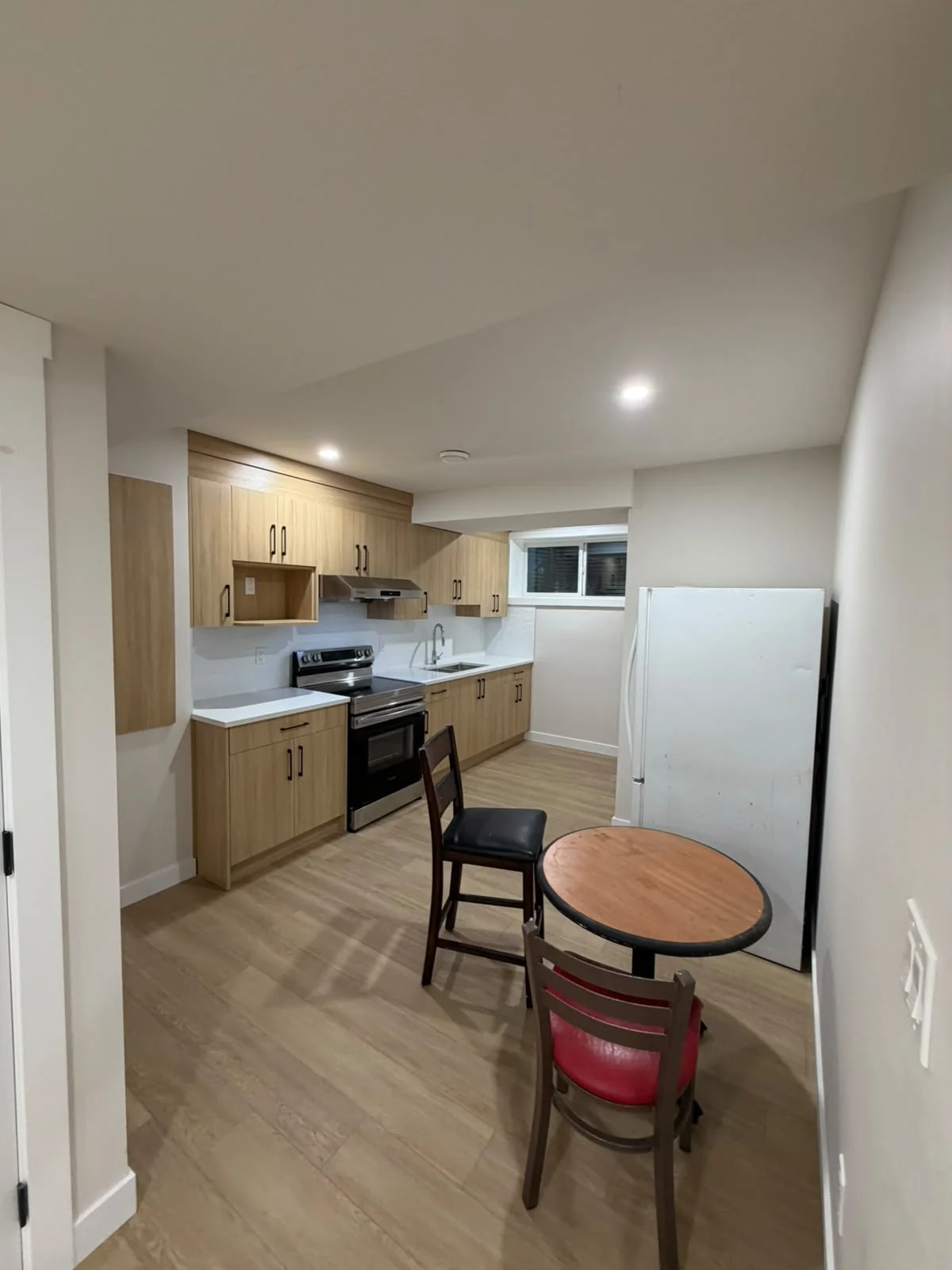 Basement kitchen renovation with wood cabinetry