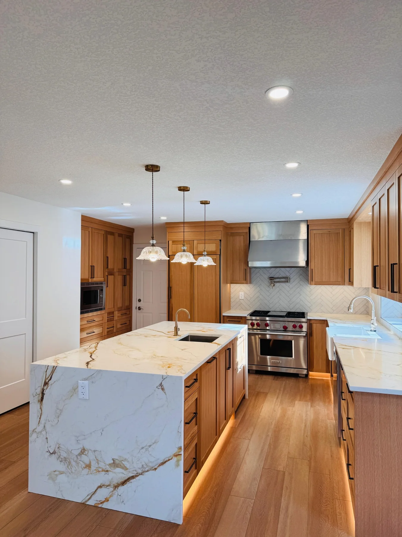 Custom wood kitchen renovation with waterfall countertop